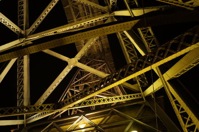 Low angle view of illuminated bridge against sky at night