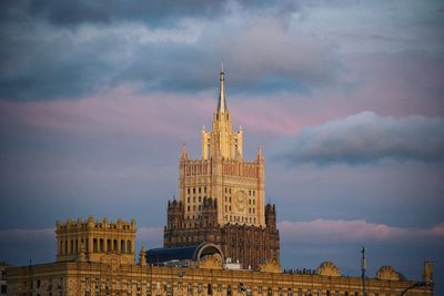 Tower of building against cloudy sky