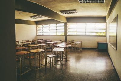 Empty chairs and table in classroom