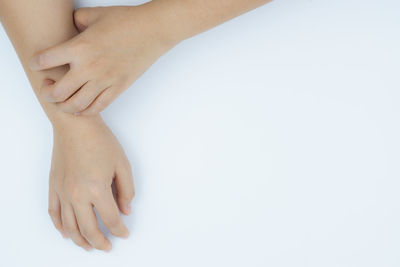 Close-up of woman hand over white background