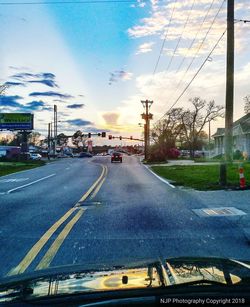 Road by city against sky