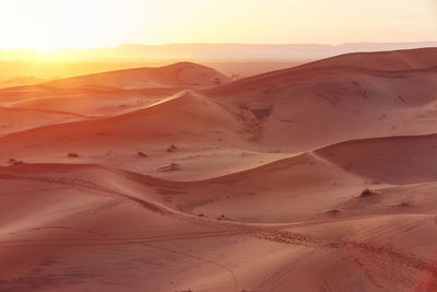 Scenic view of desert against sky during sunset