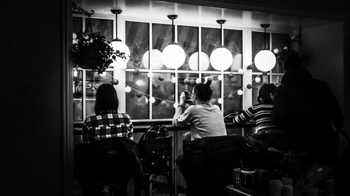 Rear view of people standing in restaurant