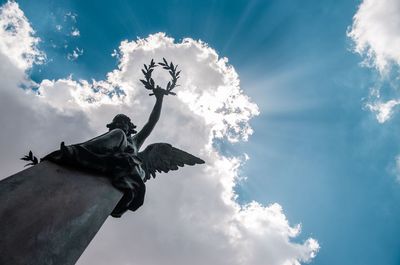 Low angle view of angel statue against sky