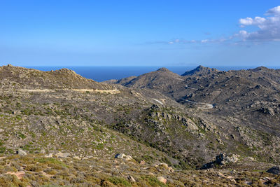 Scenic view of mountains against blue sky