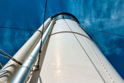 Low angle view of pipe against blue sky