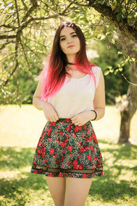 Smiling young woman in park