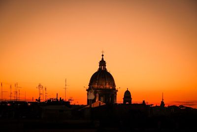 Silhouette buildings against sky during sunset