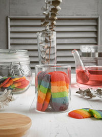 Close-up of multi colored glass on table