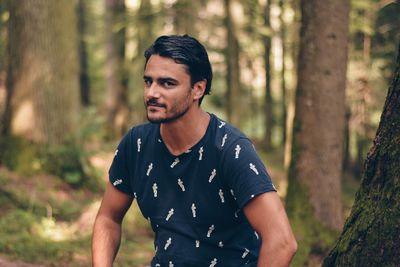 Young man standing in forest