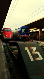 Train on road in city against sky