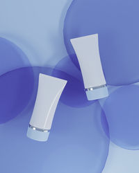 Low angle view of illuminated lamp against blue background