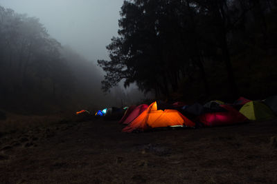 Tent on field against sky at night