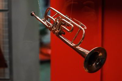 Close up of trumpet hanging from strings