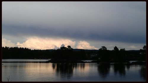 Scenic view of lake against cloudy sky