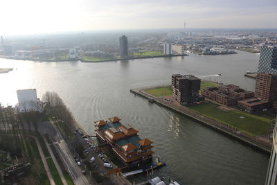 High angle view of bridge over river by buildings in city