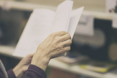 Close-up of hand holding book