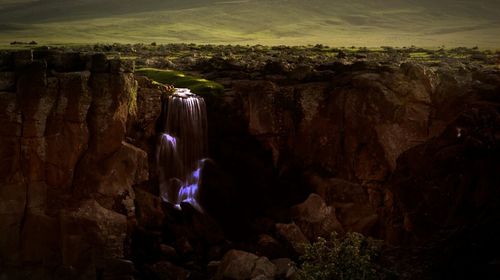 Man looking at waterfall