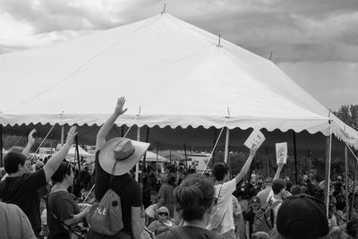 Crowd at music concert against sky