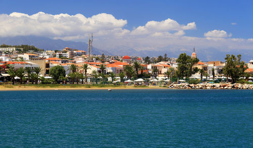 View of calm sea against built structures