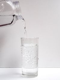 Close-up of drink in glass against white background