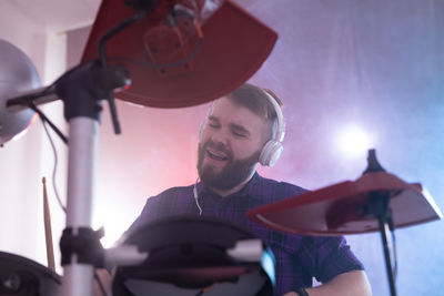 Low angle view of man holding camera at music concert