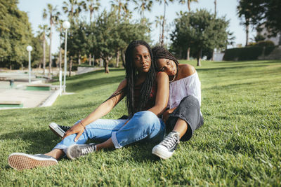 Full length of happy woman lying on grass