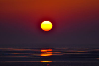 Scenic view of sea against romantic sky at sunset