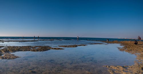 Scenic view of sea against clear blue sky