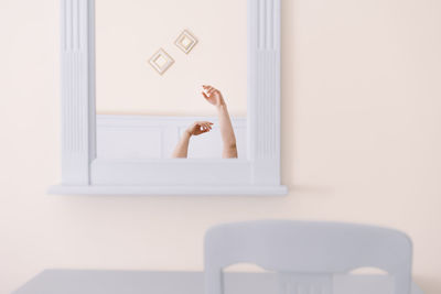 Man hands raised on mirror at home