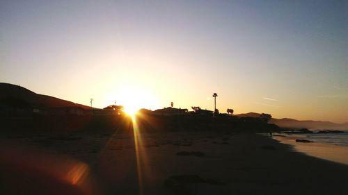 Scenic view of beach against sky during sunset