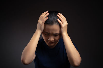 Portrait of a teenage girl over black background