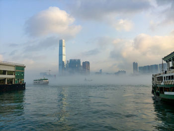 Panoramic view of sea and buildings against sky