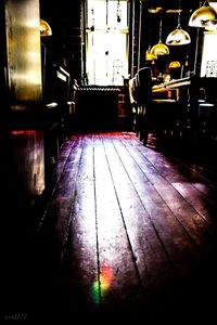 Empty chairs and tables in illuminated restaurant