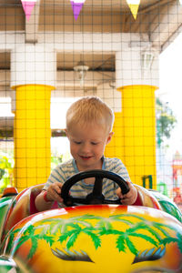 Smiling boys in amusement park ride