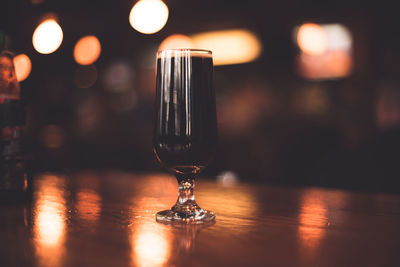 Close-up of illuminated lamp on table