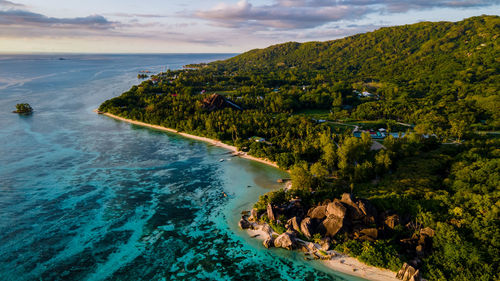 High angle view of sea and mountains against sky