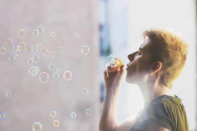 Portrait of man holding bubbles