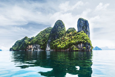 Scenic view of rocks in sea against sky