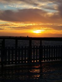 Scenic view of sea against orange sky