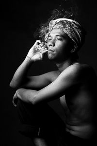 Midsection of a man smoking cigarette