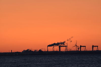 Scenic view of sea against orange sky