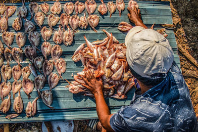 Man and vegetables at market stall