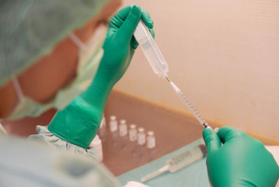 Cropped image of doctor filling syringe