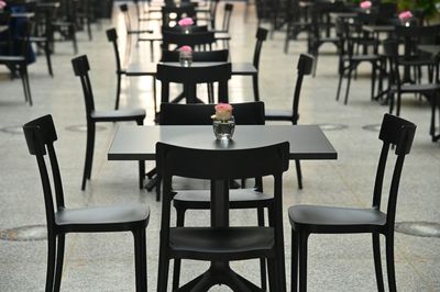 Empty chairs and tables at cafe