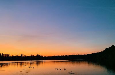 Scenic view of lake against sky during sunset