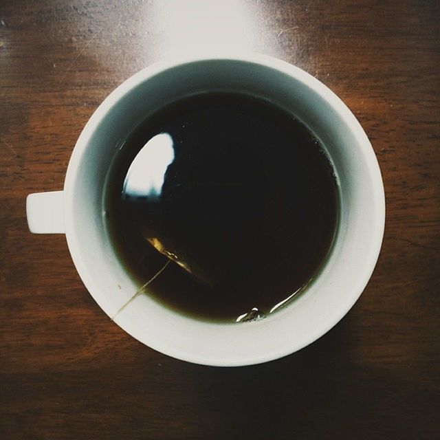 indoors, table, food and drink, drink, refreshment, coffee cup, still life, high angle view, freshness, directly above, saucer, coffee - drink, cup, wood - material, coffee, close-up, no people, tea cup, overhead view, spoon