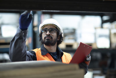 Young store worker controlling ware