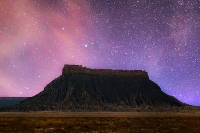 Scenic view of mountains against sky at night