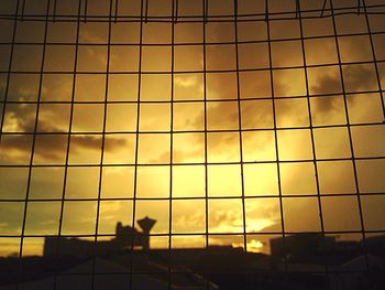 Low angle view of silhouette building against sky during sunset